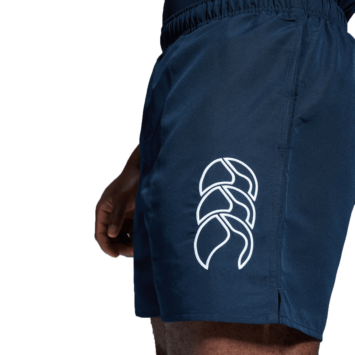 Someone wearing navy shorts from the Canterbury Tactic Short 3-Pack Bundle, featuring a white logo on the side.