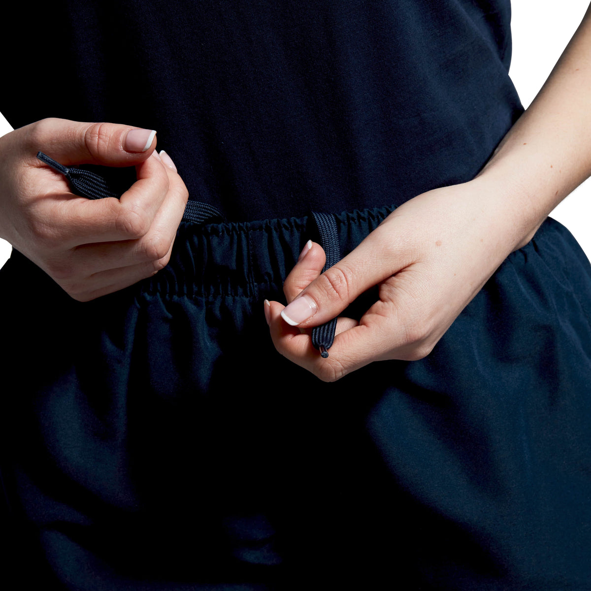 A close-up shows drawstrings being tied on the Women&#39;s Canterbury Open Hem Stadium Pant, featuring the Canterbury logo, ready for a rigorous rugby training session.