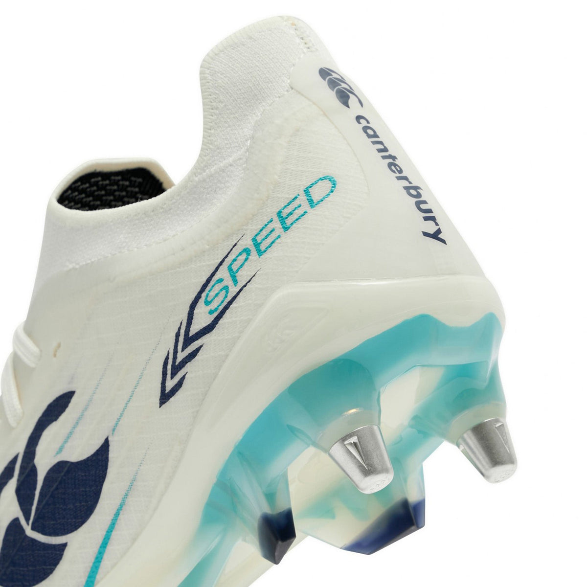 Close-up of the Canterbury Speed Falcon 2.0 Elite SG rugby boot in White/Baltic Green, featuring metal studs, blue “SPEED” text, and light blue accents near the heel and sole—a perfect choice from Canterbury for soft ground play.