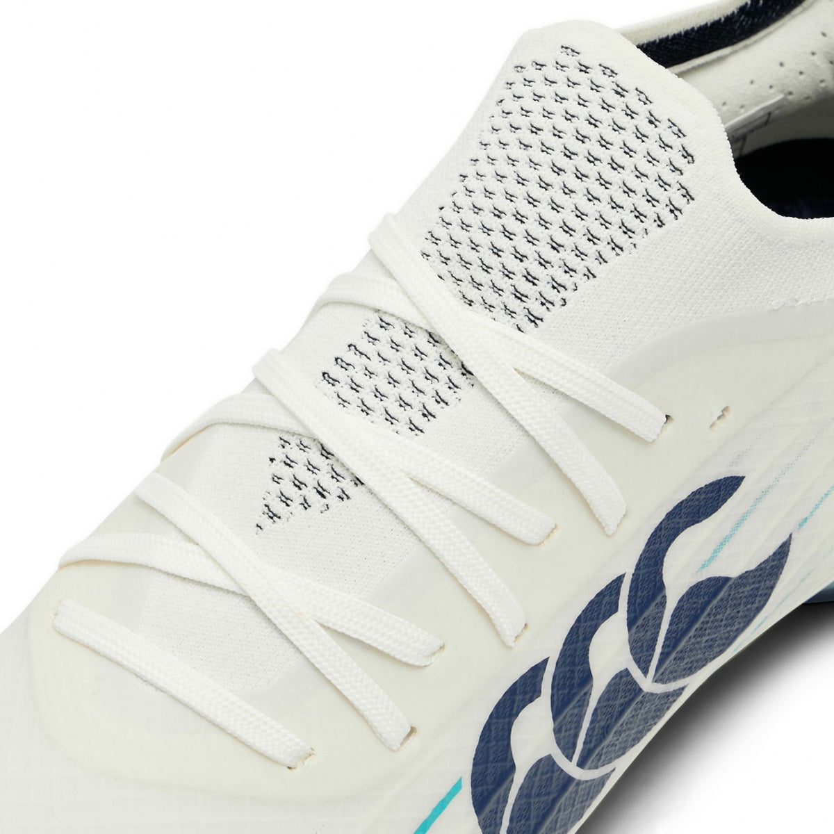 Close-up of a white Canterbury Speed Falcon 2.0 Elite SG rugby boot featuring white laces, a knitted upper section, and a Baltic Green stylized logo on the side, designed for optimal soft ground performance.
