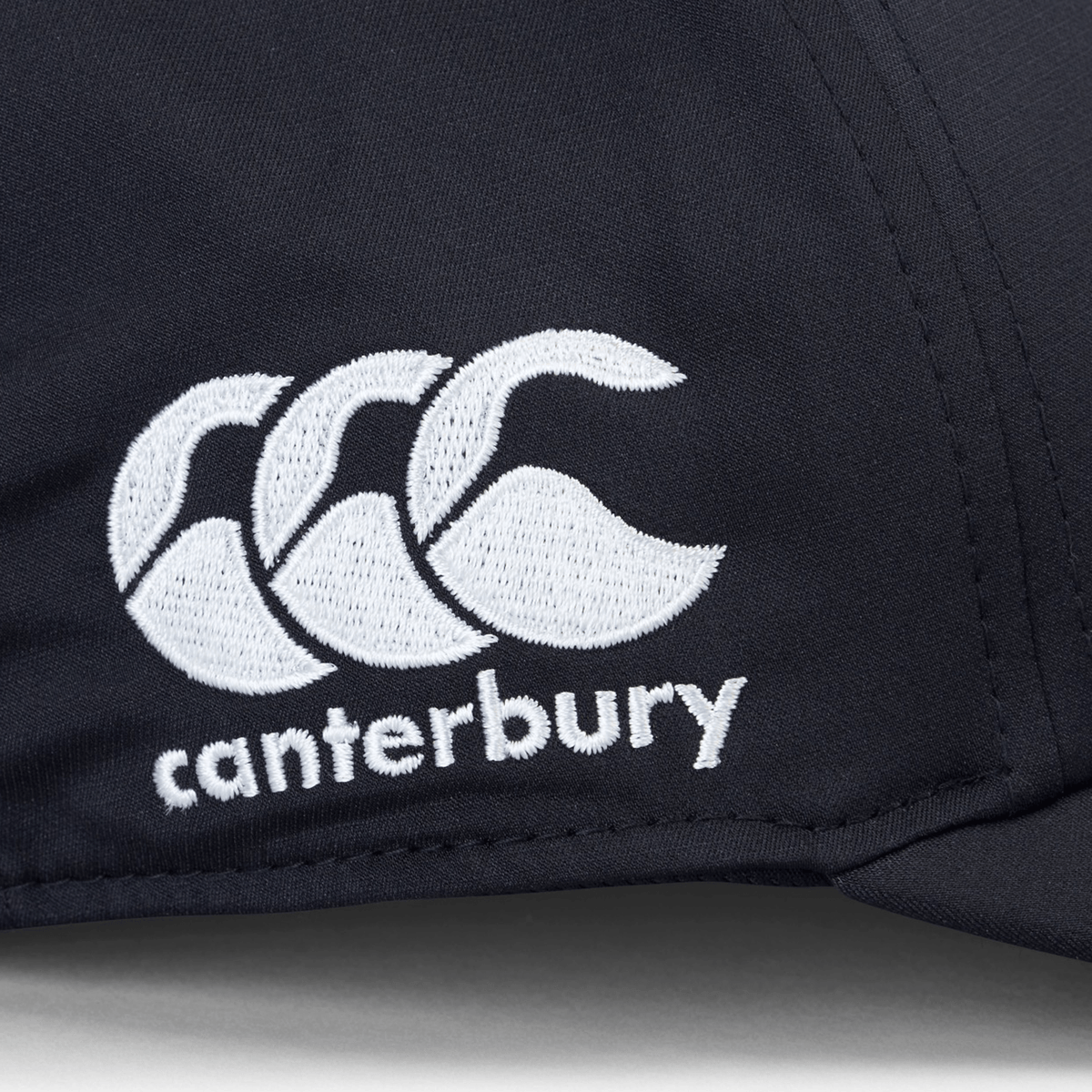 Close-up of the Ireland 25/26 Tech Logo Cap by Canterbury, a black adjustable sports cap with white embroidered Canterbury logo and text.
