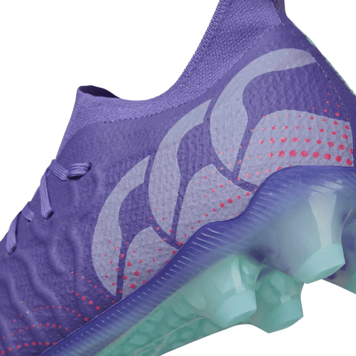 Close-up of a Canterbury Speed Infinite Elite FG - Prism Violet/Verbena athletic shoe with a patterned design and a translucent sole, featuring a VAPOSKIN membrane.